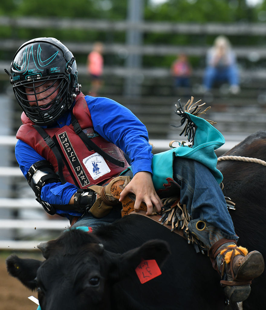 Ayden Bebout of Peculiar participates in the bareback steer riding competition